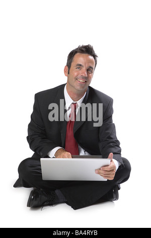 Businessman sitting with laptop computer isolated on white Stock Photo