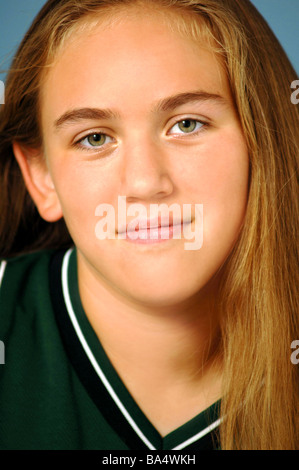 Young white female athlete in school basketball uniform looks into the camera Stock Photo