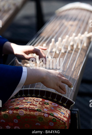 Closeup of a Japanese woman playing Koto Stock Photo