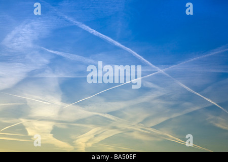 Chemtrails, water vapour trails in the blue sky Stock Photo