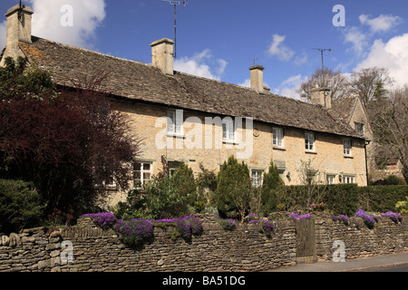 Row of stone terraced cottages in Barnsley, The Cotswolds, Gloucestershire, UK in spring Stock Photo