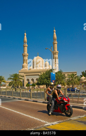 Motorbike passing in front of the Jumeirha Mosque Dubai Stock Photo