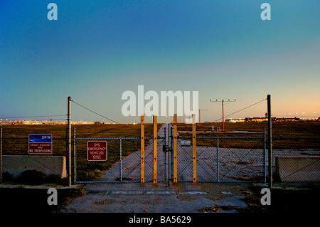 Security gate and runway lights at major international airport, DFW international Stock Photo