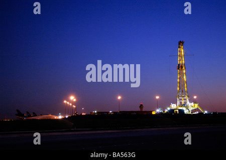 Illuminated drilling rig on public airport property at DFW international, airport Stock Photo