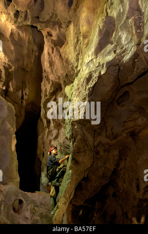 A caver exploring the limestone caves of Khao Wong National Park Khao Chamao Khao Wong in Rayong Thailand Stock Photo