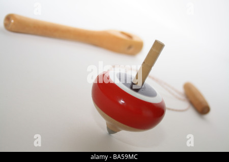 red, white and blue brightly coloured spinning top and string toy Stock Photo