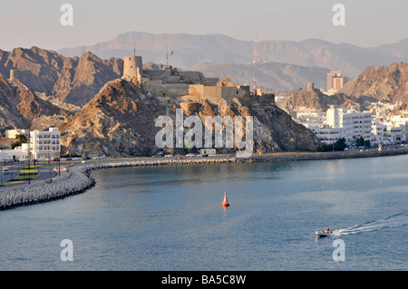 Hilltop fort waterfront and harbour at Muttrah also spelt as Mutrah part of Muscat Oman Stock Photo