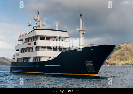 Superyacht 'Big Aron' underway off St Kitts seen from the forward quarter with St Kitts behind Stock Photo