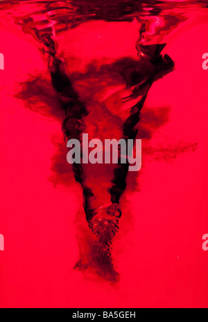 Side view of an underwater red vortex swirl with dark ink clouds isolated Stock Photo