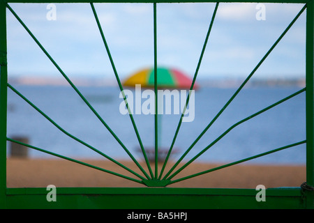 View on sandy beach with umbrella in off season. Stock Photo