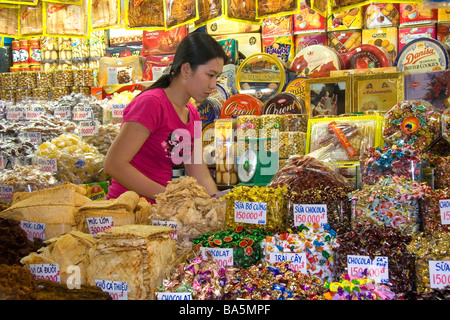 Female vendor selling treats in the Ben Thanh Market located in Ho Chi Minh City Vietnam Stock Photo