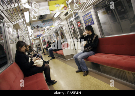 Passengers on a subway train in Tokyo Japan Stock Photo