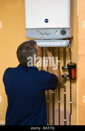 plumber / gas engineer working on an energy efficient condensing Baxi gas boiler Stock Photo
