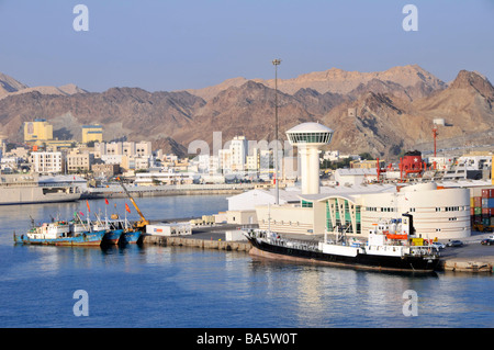 Rocky landscape waterfront and Port Sultan Qaboos at Muttrah also spelt as Mutrah part of Muscat Oman 'Gulf of Oman' Asia Stock Photo
