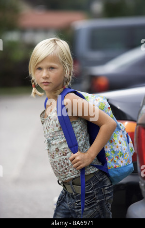 School-way girls carefully cars parks looks series people child schoolchild 7 years blond braids backpack school satchels Stock Photo