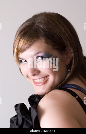 Beautiful young woman looking over shoulder Stock Photo