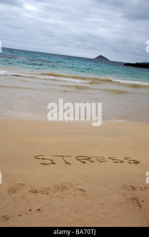 under stress at Punta Cormoran, Floreana Island, Galapagos Islands, Ecuador in September - word stress written in the sand beach, stress concept Stock Photo