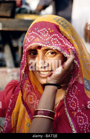 Portrait of Rajasthani woman in sari standing against white background ...