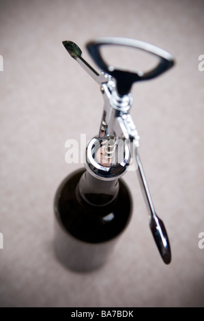 Corkscrew opening a wine bottle Stock Photo
