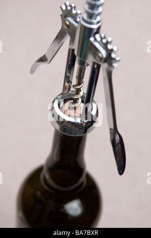 Corkscrew attached to wine bottle to remove cork Stock Photo