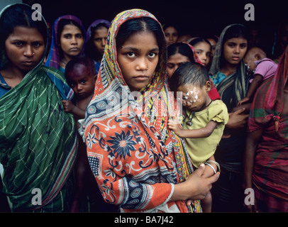 Bengali women and children queue at a medical centre Stock Photo