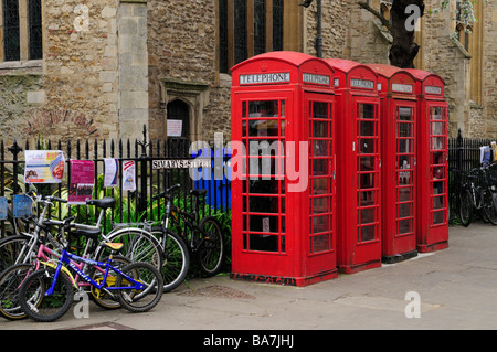 Group of four telephone boxes and bicycles outside Great St Marys Church, Cambridge England Uk Stock Photo