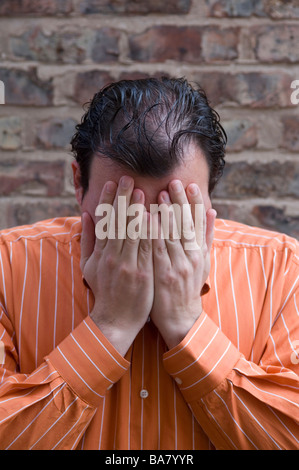 Man head in hands crying Stock Photo