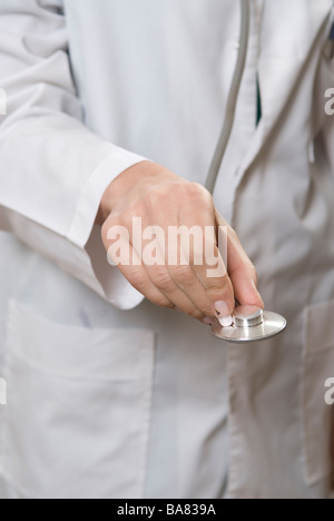 Doctor's hand holding stethoscope Stock Photo