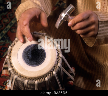 A Tabla (dayan tabla) being played, with fingers and a hammer. (Zakir Hussain is the player) Stock Photo