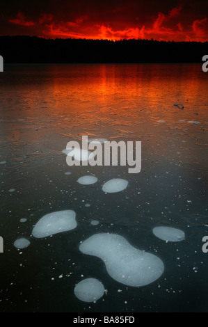 Air bubbles in the ice on the lake Ravnsjø in Våler kommune, Østfold fylke, Norway. The lake is a part of the water system called Morsavassdraget. Stock Photo