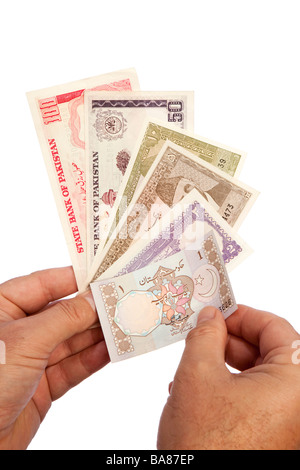 Money male hands holding handful of Pakistani currency Stock Photo