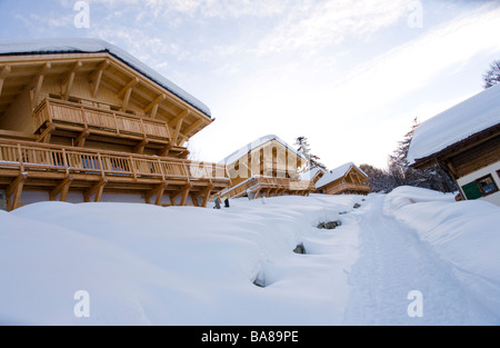 Winter scene of snow covered ski chalets in an Alpine ski resort. Stock Photo