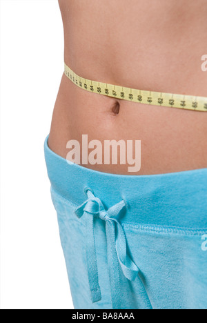 Young woman measuring waist with tape measure Stock Photo