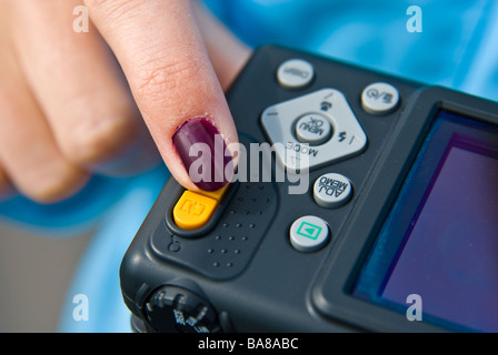 Girl with compact digital Camera taking picture | Mädchen fotografiert mit digitaler Kompaktkamera Stock Photo