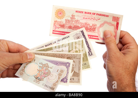 Money male hand holding handful of Pakistani currency Stock Photo