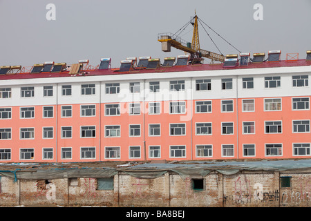 A modern apartment block with solar water heaters on the roof in Heilongjiang province in China Stock Photo