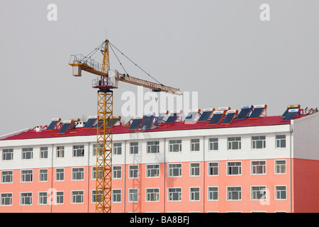 A modern apartment block with solar water heaters on the roof in Heilongjiang province in China Stock Photo