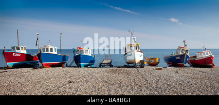 seven fishing boats on the beach in Beer, Dorset Stock Photo