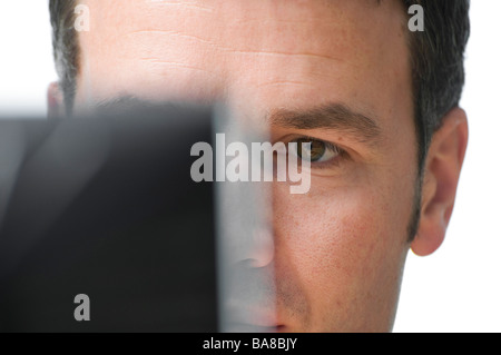 man looking at computer monitor Stock Photo