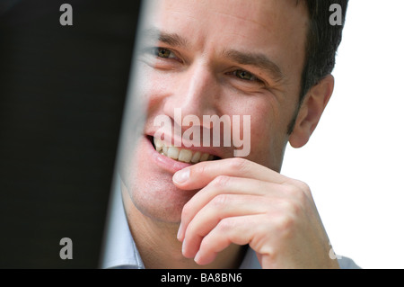 man looking at computer monitor Stock Photo