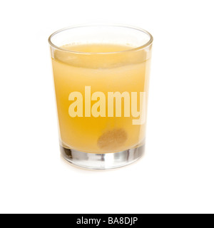 Effervescent vitamin C tablet dissolving in a glass of water. Isolated on a white studio background. Stock Photo