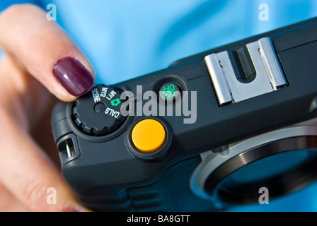 Girl with compact digital Camera taking picture | Mädchen fotografiert mit digitaler Kompaktkamera Stock Photo