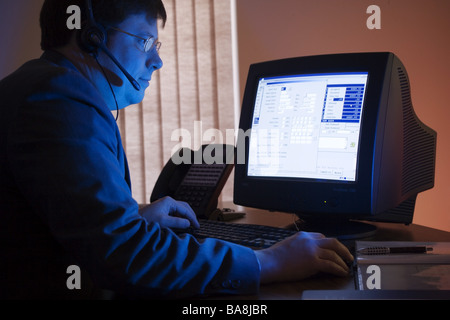 Executives at work in office setting with computer. Stock Photo