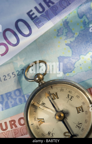Euro notes and antique compass Stock Photo