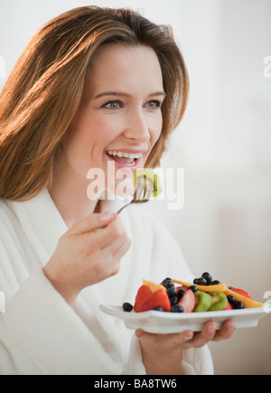 Woman eating fresh fruit Stock Photo