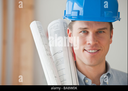 Architect holding blueprints Stock Photo