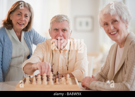 Senior adults playing chess Stock Photo