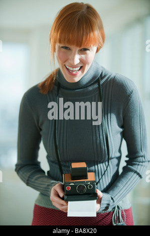Woman holding vintage camera Stock Photo