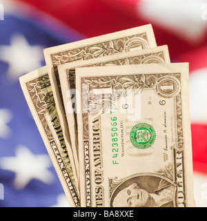 Close up of dollar bills and American flag Stock Photo