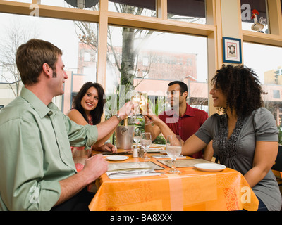 Friends toasting in restaurant Stock Photo